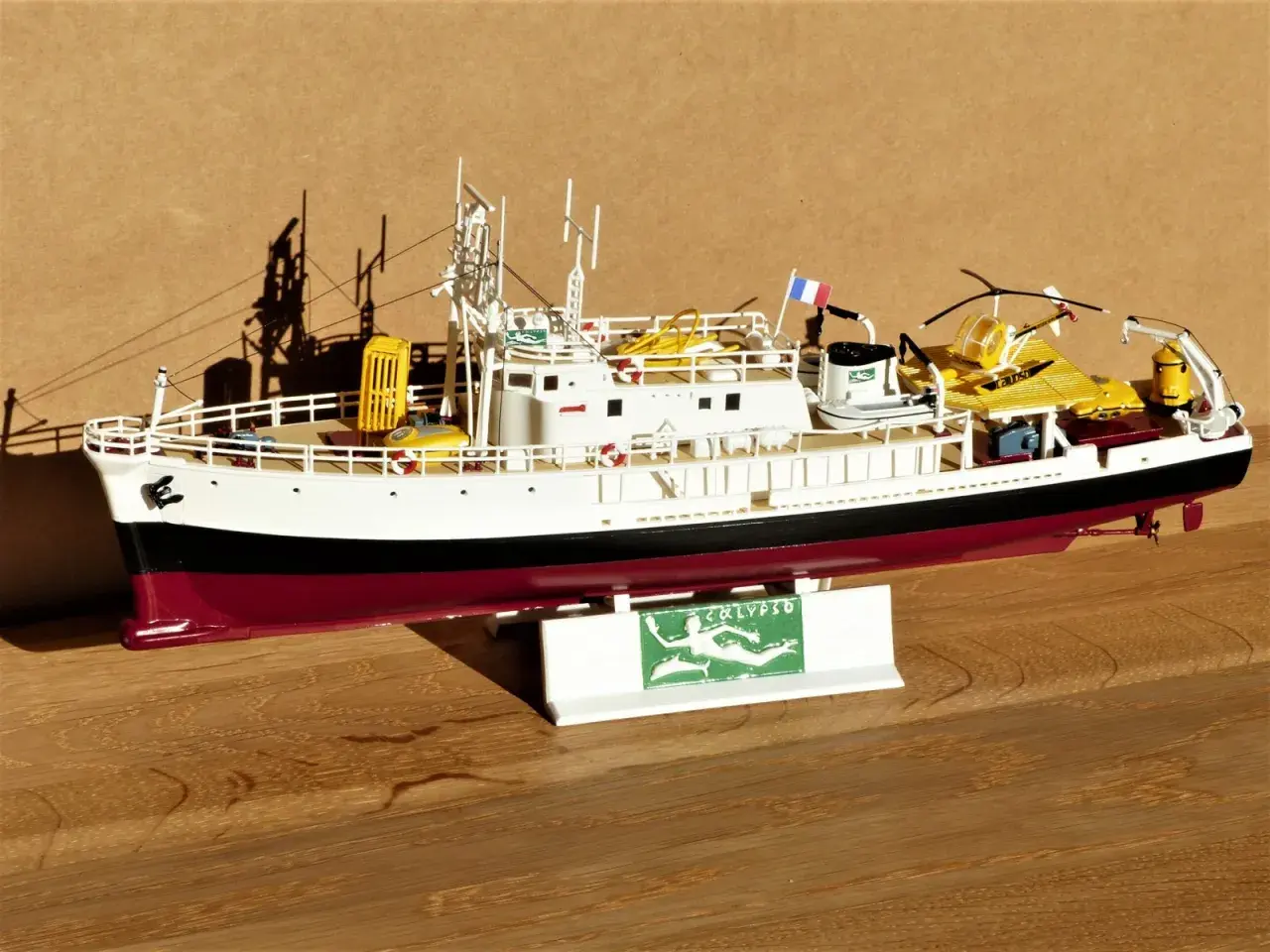 Modell des Forschungsschiffs Calypso mit gelbem Käfig und U-Boot.
