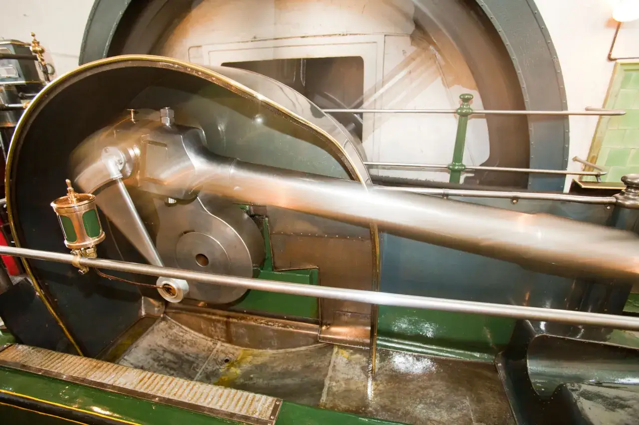 Bewegung eines Kolbens in einer Dampfmaschine, ein Symbol für den Beginn der Industrialisierung.